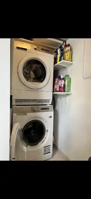 a washer and dryer in a small room at Koselig bolig med stor stue, 10 min from Solsiden! in Trondheim
