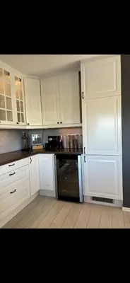 a white kitchen with white cabinets and an oven at Koselig bolig med stor stue, 10 min from Solsiden! in Trondheim
