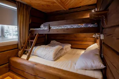 two bunk beds in a room with a window at Trysilfjellet Sør 802 Anex in Trysil