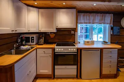 a kitchen with white cabinets and a stove top oven at Trysilfjellet Sør 802 Anex in Trysil
