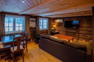 a living room with a couch and a table at Trysilfjellet Sør 802 Anex in Trysil