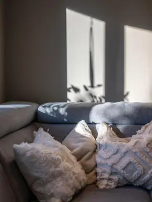 a couch with pillows on it in a living room at Historic Bergen House with Sunny Terrace in Bergen
