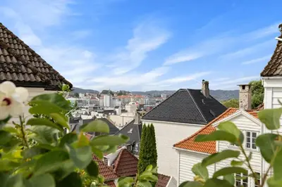 a view of the roofs of houses in a city at Historic Bergen House with Sunny Terrace in Bergen