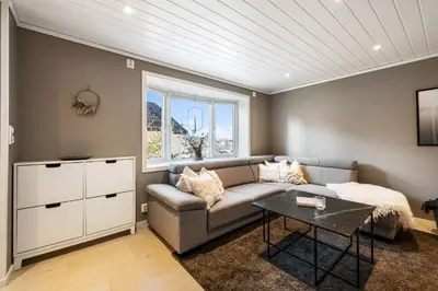 a living room with a couch and a table at Historic Bergen House with Sunny Terrace in Bergen
