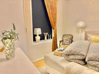 a living room with a couch and a window at 2 bedroom apartment historical downtown by the sea in Ålesund
