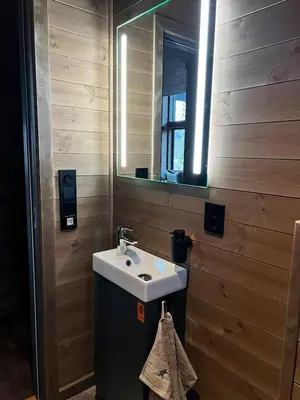 a bathroom with a sink and a mirror at Reno Hytta in Eggedal
