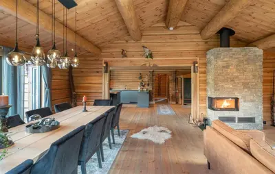 a dining room with a long table and a fireplace at 5 Bedroom Beautiful Home In Tuddal in Tuddal