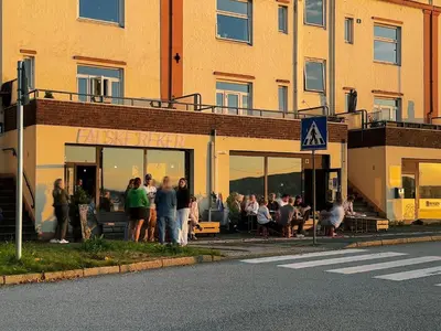 a group of people standing outside of a building at Moderne leilighet med sjøgløtt og balkong in Bergen