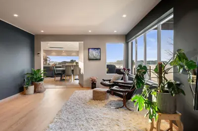a living room filled with furniture and lots of windows at Luxury Seafront Villa with Panoramic Views in Veland