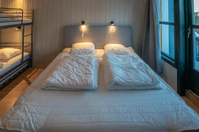 a large bed in a bedroom with two bunk beds at Bakkebyvegen 22A in Trysil