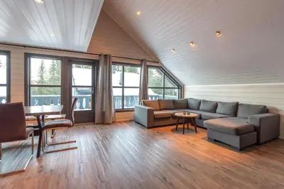 a living room with a couch and a table at Bakkebyvegen 22A in Trysil