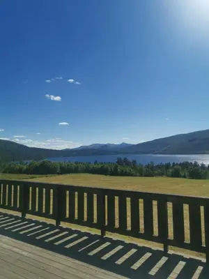 a wooden bridge with a view of the water at Åsrud seter i Jotunheimen in Randsverk