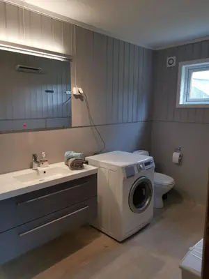 a bathroom with a washing machine and a sink at Åsrud seter i Jotunheimen in Randsverk