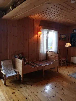 a bedroom with a large bed and a window at Åsrud seter i Jotunheimen in Randsverk