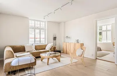 a living room with a couch and a table at Lev livet i Bergen - Stor moderne leilighet in Bergen