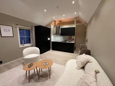 a living room with a couch and a table at Sandvik's stuen in Bergen