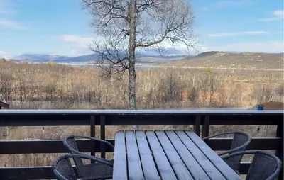 a wooden bench sitting on a balcony with a view at 4 Bedroom Awesome Home In Rjukan in Rjukan