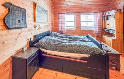 a bed in a room in a log cabin at 4 Bedroom Awesome Home In Rjukan in Rjukan