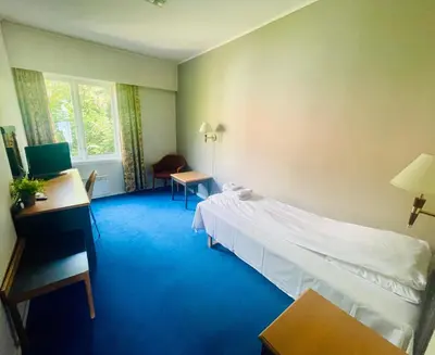 a hotel room with a bed and a desk at Suldal Hotell in Sand