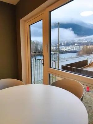 a table and chairs in front of a window at Central 2-Bedroom Apartment in Voss in Vossevangen