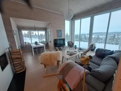 a living room with a couch and a table at Hytte Hummelfjell, Os in Os
