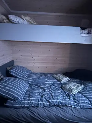 a blue bed with two pillows on top of it at Hytte Hummelfjell, Os in Os