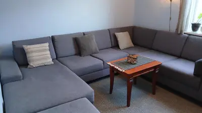 a living room with a couch and a table at The house by the waterfall in Breim