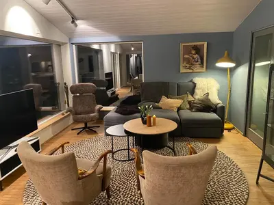 a living room with a couch and a table and chairs at Modern, spacious top apartment in Lii