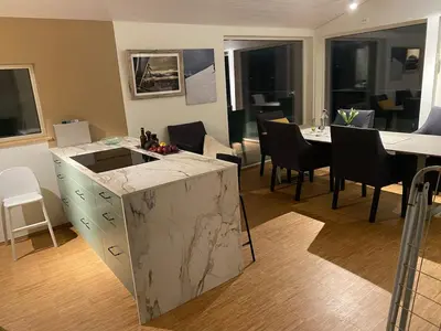 a kitchen and dining room with a table and chairs at Modern, spacious top apartment in Lii