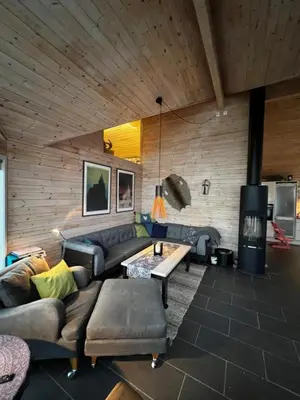 a living room with a couch and a table at Lunvik - Flott hytte ved Nysætervatnet in Sykkylven