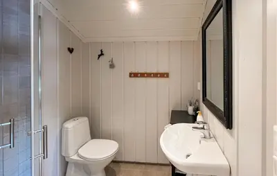 a white bathroom with a toilet and a sink at Gorgeous Home In Sjusjøen With Wifi in Sjusjøen