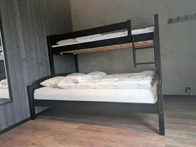 a black bunk bed with white pillows on it at Modern cabin with jacuzzi near Trysil alpine in Trysil