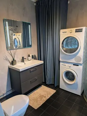 a bathroom with a washing machine and a washer at Modern cabin with jacuzzi near Trysil alpine in Trysil