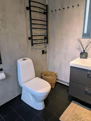 a bathroom with a white toilet and a sink at Modern cabin with jacuzzi near Trysil alpine in Trysil
