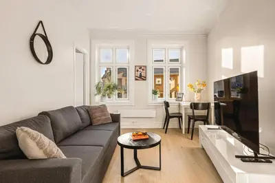a living room with a couch and a table at City Center Apartment - Top location in Bergen