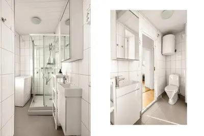 a white bathroom with a sink and a toilet at City Center Apartment - Top location in Bergen