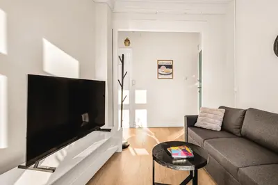 a living room with a couch and a flat screen tv at City Center Apartment - Top location in Bergen