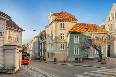 a row of houses on a city street with a bus at City Center Apartment - Top location in Bergen
