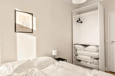 a bedroom with a bed and a closet with towels at City Center Apartment - Top location in Bergen