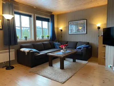 a living room with a couch and a coffee table at Leilighet i Fageråsen, Trysil, med ski inn og ut in Trysil