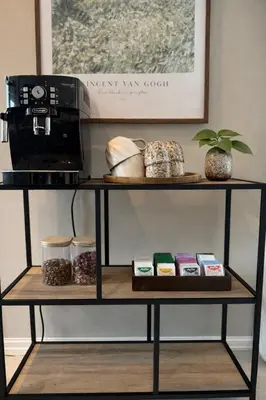 a shelf with a coffee maker and a microwave at Private house on cider farm - fjord, beach & jetty in Sogndal