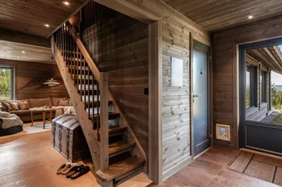 a room with a wooden staircase in a house at Lykka - lovely cabin with amazing view in Torpo