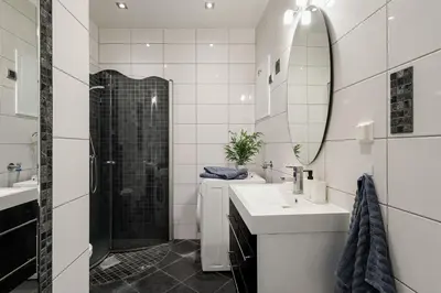 a bathroom with a shower and a sink and a mirror at NEW! I Modern Comfort in the Heart of Bergen in Bergen