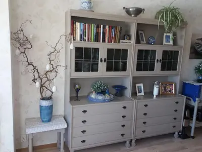 a large white cabinet with a vase on top of it at Synnseter in Lii