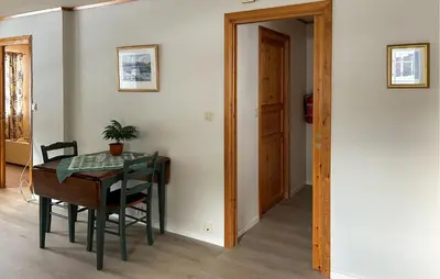a dining room with a table and a chair and a door at Gorgeous Apartment In Verma With Wifi in Verma