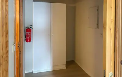 a fire extinguisher hanging on a wall in a room at Gorgeous Apartment In Verma With Wifi in Verma