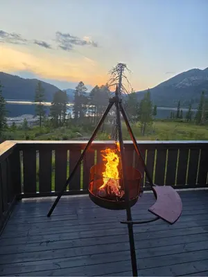 a fire in a basket on a deck with a view at Kilodden, Lakeside Mountain Cabin with Stunning Views in Tuddal
