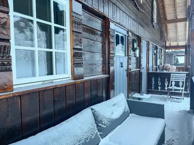 a porch with a couch in front of a building at Bjønabakkens oase in Beitostøl