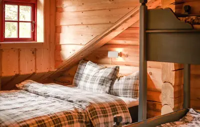 a bedroom with a bed in a log cabin at Awesome Apartment In Bjorli With Wifi in Bjorli