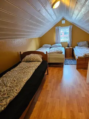 a bedroom with two beds and a window at Charming and cozy house in Vindafjord in Dørheim